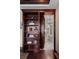 Hidden doorway disguised as bookshelves, opening to reveal a luxurious bathroom with an elegant bathtub at 5909 Oxford Moor Blvd, Windermere, FL 34786