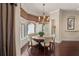 Elegant dining area featuring a round table with plush seating, a decorative chandelier, and large windows at 5909 Oxford Moor Blvd, Windermere, FL 34786