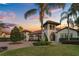 An inviting front exterior with luscious landscaping and a brick driveway at 5909 Oxford Moor Blvd, Windermere, FL 34786