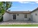 Exterior view showcasing stone entrance with decorative door, side door, and lush lawn at 5909 Oxford Moor Blvd, Windermere, FL 34786
