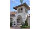 Detailed exterior view of home with a tiled roof, arched entry, and tower feature at 5909 Oxford Moor Blvd, Windermere, FL 34786