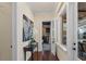 Hallway featuring dark wood floors, an elegant table with an orchid, and a view of the theater room at 5909 Oxford Moor Blvd, Windermere, FL 34786