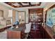 Sophisticated home office featuring coffered ceilings, custom built-ins, and elegant decor at 5909 Oxford Moor Blvd, Windermere, FL 34786