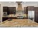 Spacious kitchen featuring granite countertops, gas range, stainless steel appliances, and dark cabinetry at 5909 Oxford Moor Blvd, Windermere, FL 34786