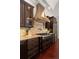 Elegant kitchen with granite countertops, stainless steel appliances, and decorative range hood at 5909 Oxford Moor Blvd, Windermere, FL 34786