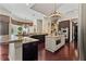 Spacious kitchen featuring a center island, dark wood cabinetry, and recessed lighting for a warm and inviting atmosphere at 5909 Oxford Moor Blvd, Windermere, FL 34786