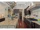 Gourmet kitchen showcasing dark wood cabinetry, stainless steel appliances and granite countertops at 5909 Oxford Moor Blvd, Windermere, FL 34786