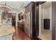 Gourmet kitchen with stainless steel refrigerator, dark cabinets, and hardwood flooring at 5909 Oxford Moor Blvd, Windermere, FL 34786