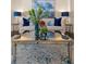 Beautifully staged living room with a beige couch, blue throw pillows and a mirrored coffee table at 5909 Oxford Moor Blvd, Windermere, FL 34786