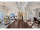 Living room featuring dark hardwood floors, multiple arched entryways, and views into the dining room at 5909 Oxford Moor Blvd, Windermere, FL 34786