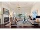 Bright living room showcasing a fireplace, detailed ceiling and access to the outdoor area at 5909 Oxford Moor Blvd, Windermere, FL 34786