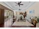 Bright, open living room featuring hardwood floors, tray ceilings, and access to an outdoor living space at 5909 Oxford Moor Blvd, Windermere, FL 34786