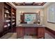 A cozy office featuring a large desk and bookshelf, complemented by decorative lighting and a neutral-toned area rug at 5909 Oxford Moor Blvd, Windermere, FL 34786