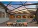 Beautiful screened-in pool and spa area, with brick patio and comfortable seating under a sunset sky at 5909 Oxford Moor Blvd, Windermere, FL 34786