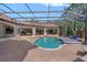 A gorgeous screened in backyard pool with brick patio and tile spa at 5909 Oxford Moor Blvd, Windermere, FL 34786