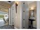 Beautiful powder room with a modern pedestal sink, decorative mirror, and stylish lighting fixtures at 5909 Oxford Moor Blvd, Windermere, FL 34786