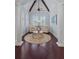 Cozy sitting area with hardwood floors, white pillars, and comfortable armchairs at 5909 Oxford Moor Blvd, Windermere, FL 34786
