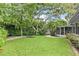 Expansive backyard featuring lush green grass, mature trees, and a well-maintained lawn, ideal for outdoor activities at 627 Darcey Dr, Winter Park, FL 32792