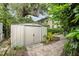 Backyard view of storage shed with brick pathway and view of the house at 627 Darcey Dr, Winter Park, FL 32792