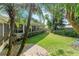 Mature landscaping in the backyard with lush green grass at 627 Darcey Dr, Winter Park, FL 32792