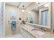 Bright bathroom features a granite countertop, ample storage, and framed mirror at 627 Darcey Dr, Winter Park, FL 32792