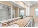 Well-lit bathroom featuring double sinks and a spacious, tiled shower at 627 Darcey Dr, Winter Park, FL 32792