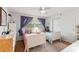 Charming bedroom featuring two twin beds and soft, natural light at 627 Darcey Dr, Winter Park, FL 32792
