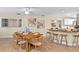 Bright dining area with seating for six and bar counter with granite countertops and modern ceiling fan at 627 Darcey Dr, Winter Park, FL 32792
