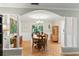 Charming dining room with wood floors and an archway to the living room at 627 Darcey Dr, Winter Park, FL 32792