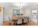Comfortable dining area with seating for six, parquet floors, and view into the living and kitchen areas at 627 Darcey Dr, Winter Park, FL 32792