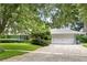 Charming home exterior with a manicured lawn, a double garage, and a brick driveway at 627 Darcey Dr, Winter Park, FL 32792