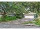 Charming home with lush landscaping, a two-car garage and large driveway at 627 Darcey Dr, Winter Park, FL 32792
