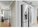 Hallway view featuring updated stainless steel appliances and access to the front door at 627 Darcey Dr, Winter Park, FL 32792