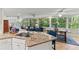 Open kitchen with granite countertops and a dining area with views of the backyard at 627 Darcey Dr, Winter Park, FL 32792
