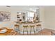 Breakfast bar area with granite countertops, wooden stools and white cabinets in an open concept kitchen at 627 Darcey Dr, Winter Park, FL 32792