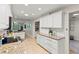 Bright kitchen featuring white cabinets, granite countertops, and stainless steel appliances at 627 Darcey Dr, Winter Park, FL 32792