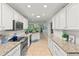 Bright kitchen with white cabinetry, stainless steel appliances, and granite countertops at 627 Darcey Dr, Winter Park, FL 32792