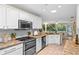 Bright kitchen with white cabinets, granite countertops and modern appliances; a chef's dream at 627 Darcey Dr, Winter Park, FL 32792