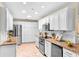 Kitchen featuring stainless appliances, white cabinets and granite countertops in an updated space at 627 Darcey Dr, Winter Park, FL 32792