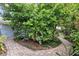 Beautiful landscaping showcases lush greenery and a charming brick pathway leading through the garden at 627 Darcey Dr, Winter Park, FL 32792