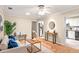 Cozy living room with hardwood floors, stylish furnishings, and access to the kitchen, creating an inviting and functional space at 627 Darcey Dr, Winter Park, FL 32792