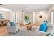 Bright living room featuring parquet floors, comfortable seating, and an adjacent dining area at 627 Darcey Dr, Winter Park, FL 32792