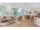 Open-concept sun room featuring tile floors, comfortable seating, and large windows with outdoor views at 627 Darcey Dr, Winter Park, FL 32792