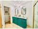 Bathroom featuring teal vanity, dual sinks, granite countertops and walk-in closet at 6653 Se 87Th St, Ocala, FL 34472
