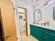 Bathroom features a vanity with teal cabinets and dual sinks at 6653 Se 87Th St, Ocala, FL 34472