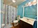 Cozy bathroom features a tiled shower, vanity with sink, and blue walls at 6653 Se 87Th St, Ocala, FL 34472