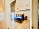Bedroom features a ceiling fan, tv and wood flooring at 6653 Se 87Th St, Ocala, FL 34472