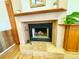 Close up of the fireplace featuring a decorative mantel and hearth with wooden floors surrounding it at 6653 Se 87Th St, Ocala, FL 34472