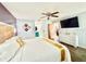 Main bedroom features a ceiling fan, television, a king bed and wooden floors at 6653 Se 87Th St, Ocala, FL 34472