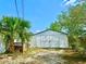 Exterior view of a large shed with white paint and double doors at 6653 Se 87Th St, Ocala, FL 34472